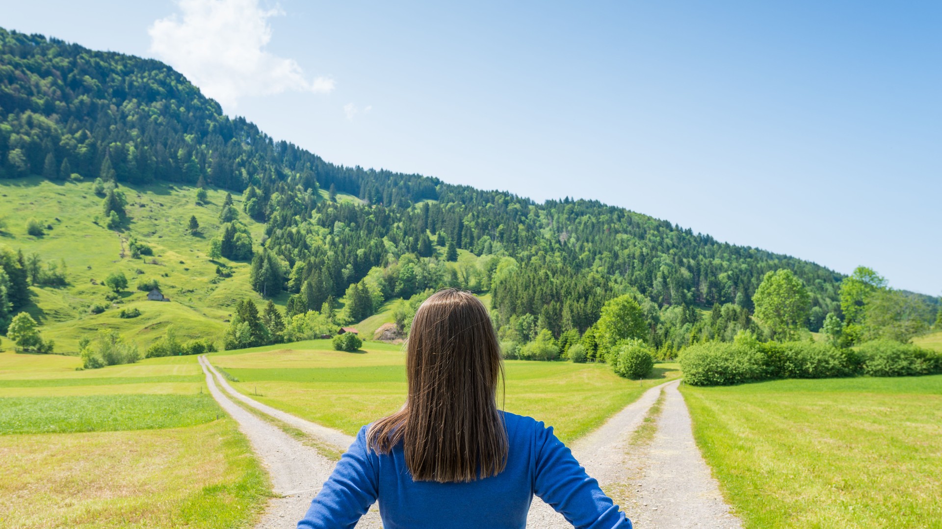 At the intersection of roads. The symbol is to make a choice. Female figure.